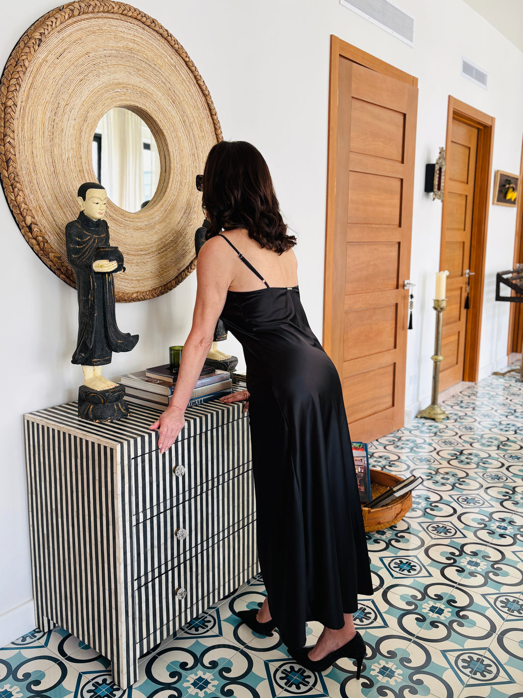 Strappy black maxi dress styled with minimal straps and flowing silhouette, front elegant look