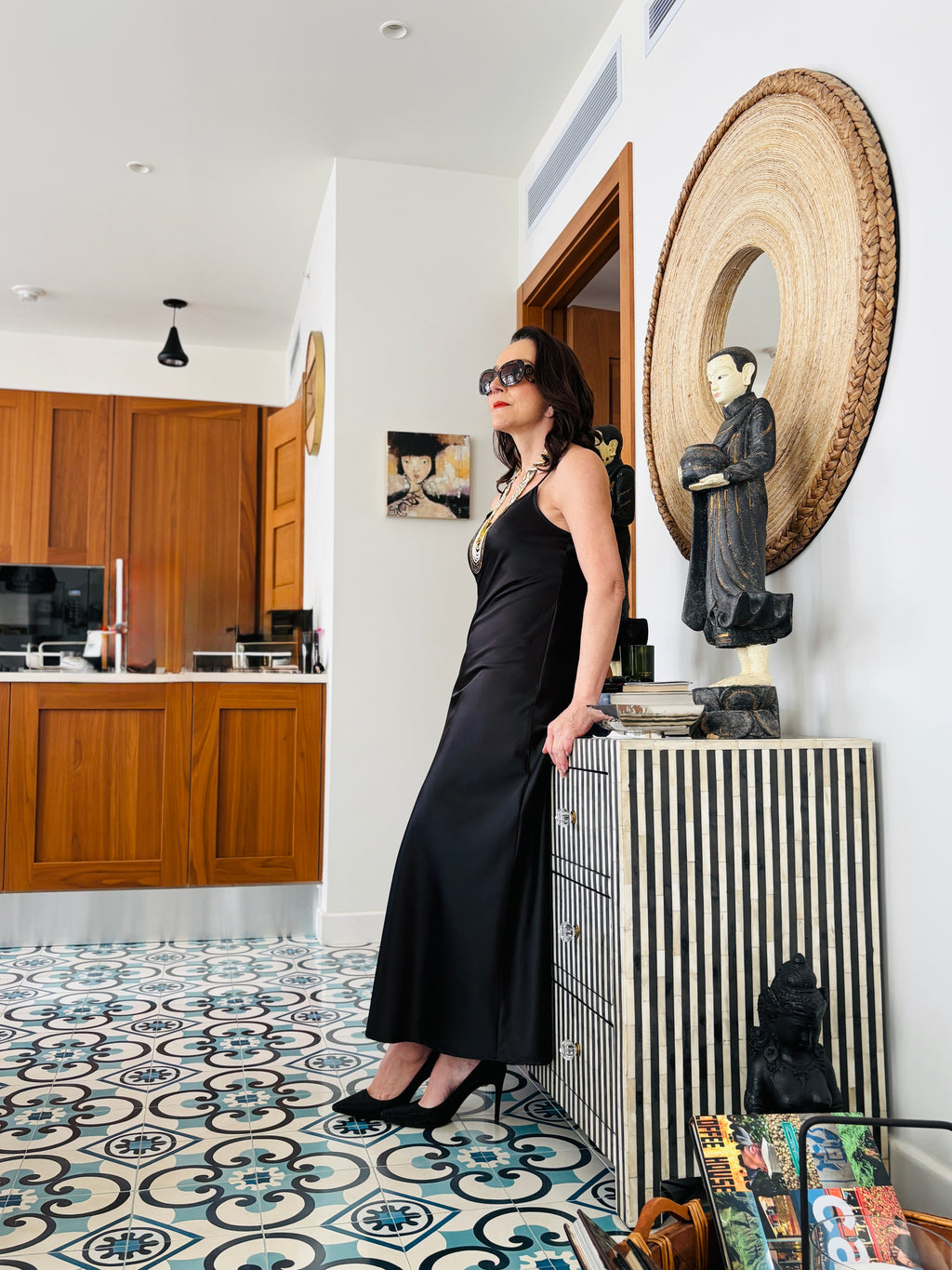 Side profile of black strappy maxi dress showcasing sleek fit and contemporary silhouette