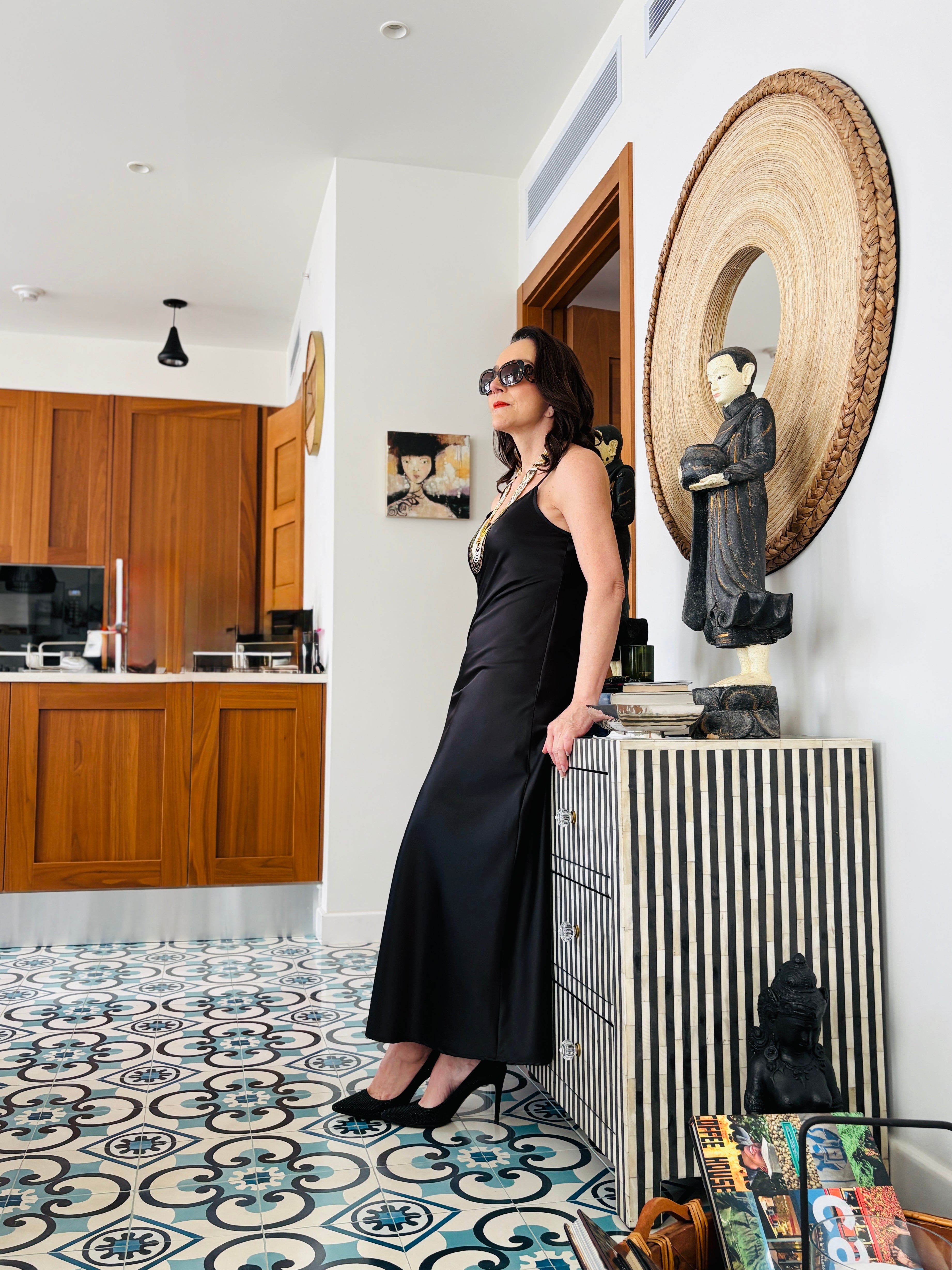 Side profile of black strappy maxi dress showcasing sleek fit and contemporary silhouette