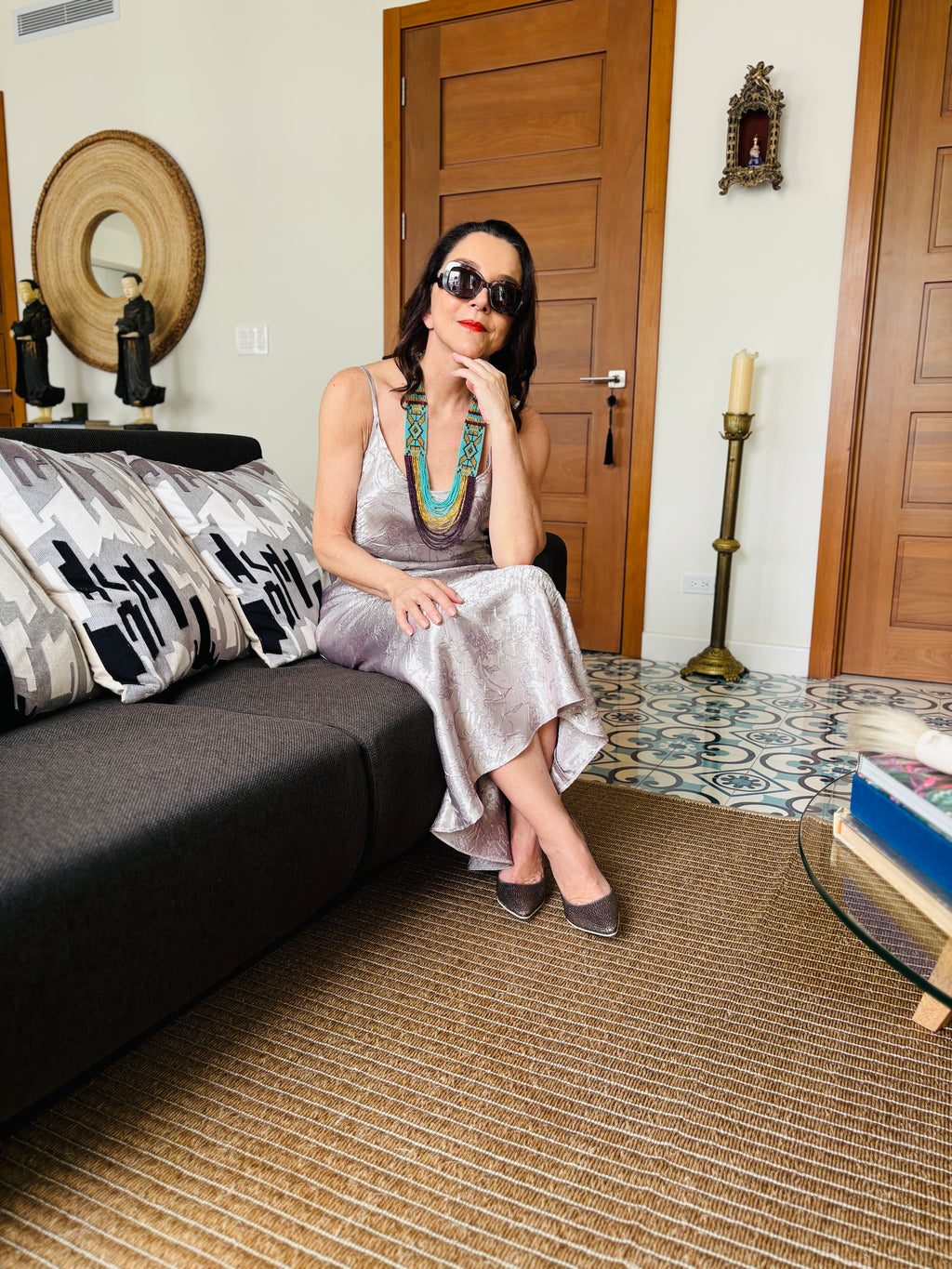 Dusty rose strappy maxi dress styled in a seated pose, elegant lifestyle indoor setting