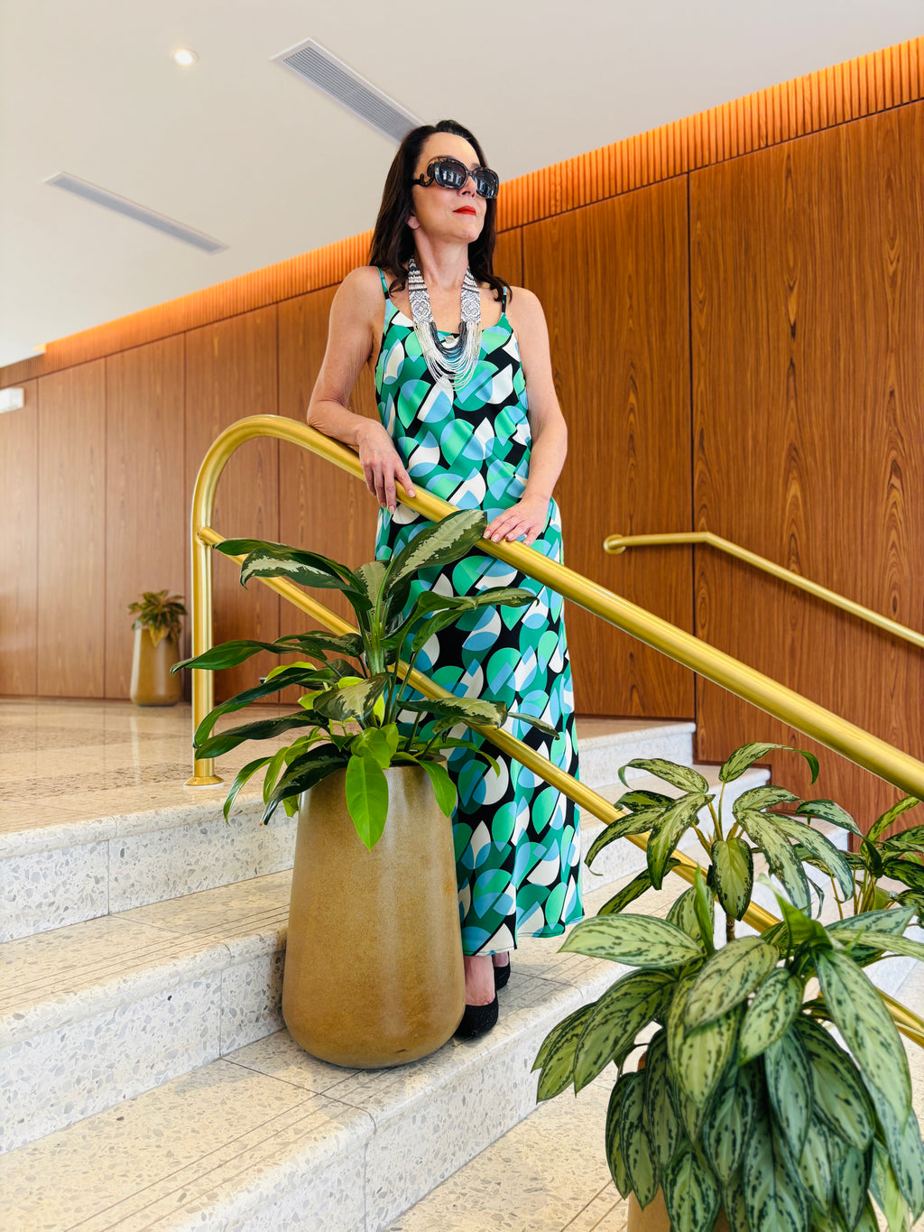 Strappy maxi dress in geo green featuring bold geometric design and flowing silhouette