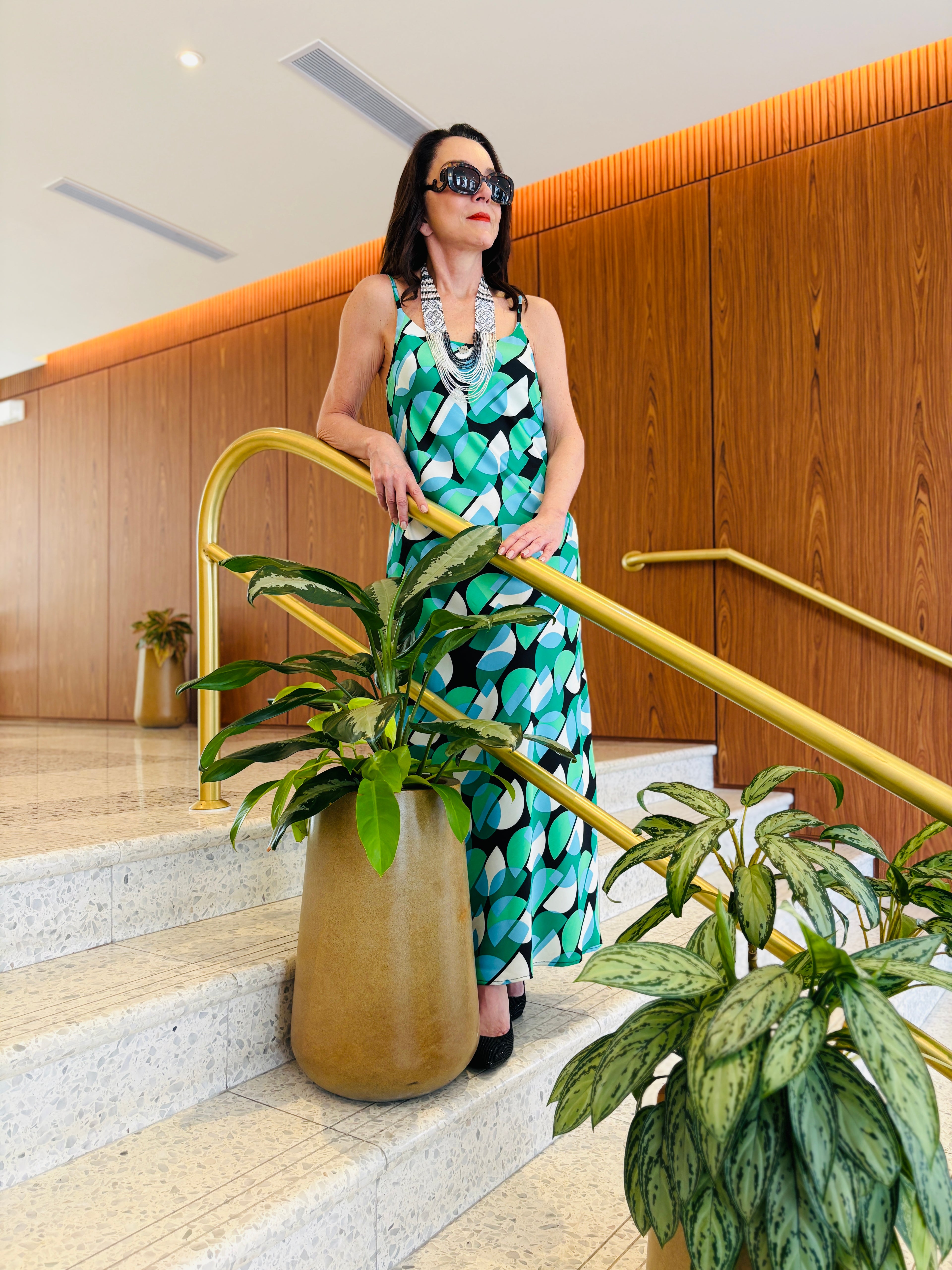 Strappy maxi dress in geo green featuring bold geometric design and flowing silhouette