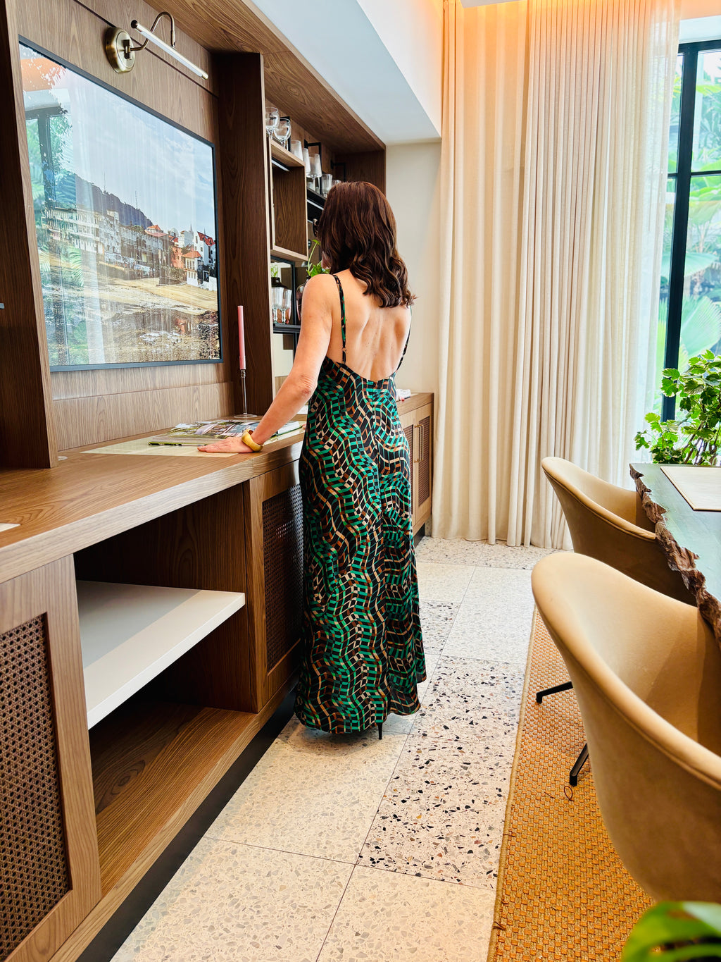 Back view of jungle green strappy maxi dress featuring open back and elegant drape