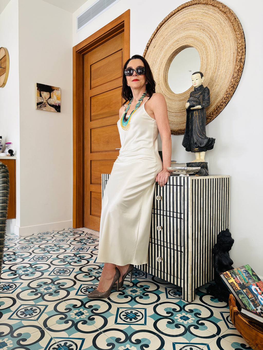 White strappy maxi dress styled in an elegant standing pose, showcasing minimalist silhouette