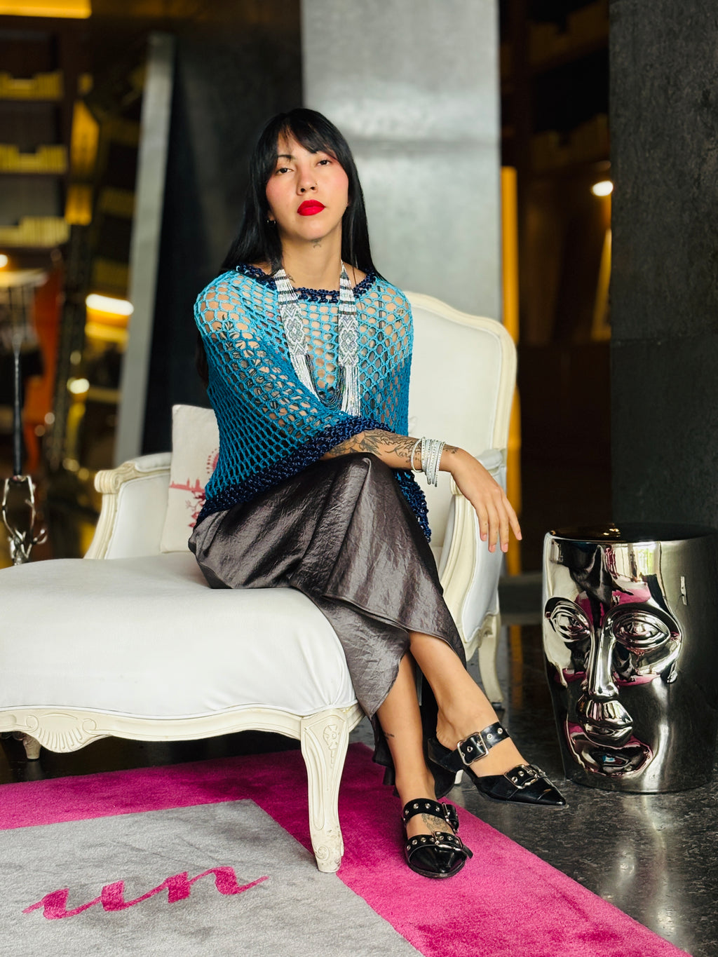 Elegant poncho worn over dress for evening style