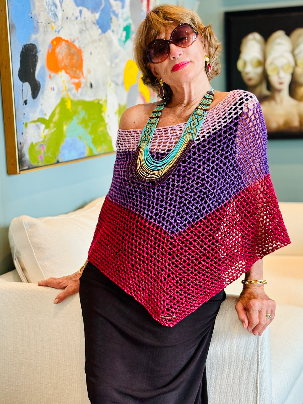 Elegant poncho worn over dress for evening look