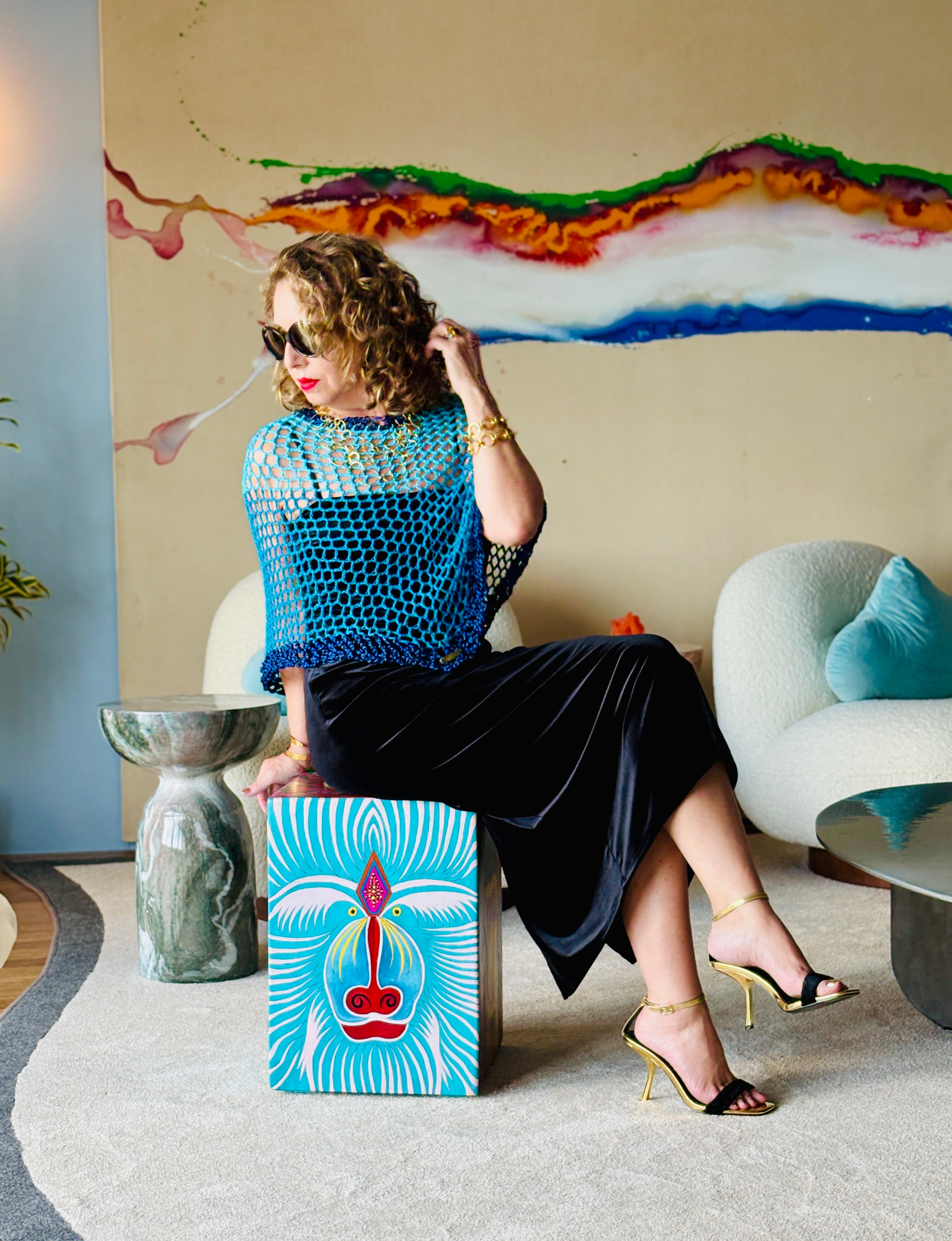 Two tone blue poncho worn in relaxed lifestyle setting