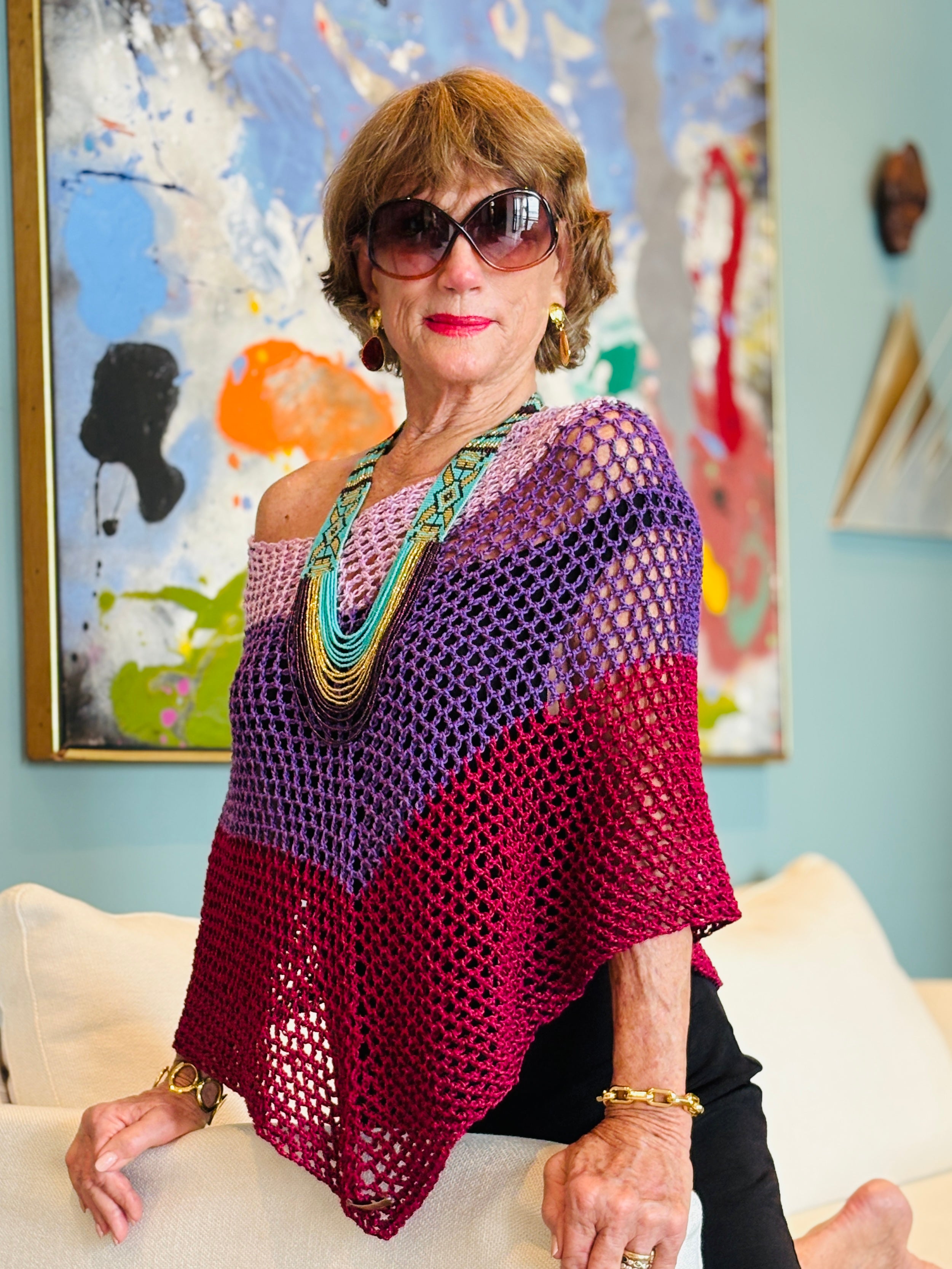 Close-up of crochet texture in pink purple poncho