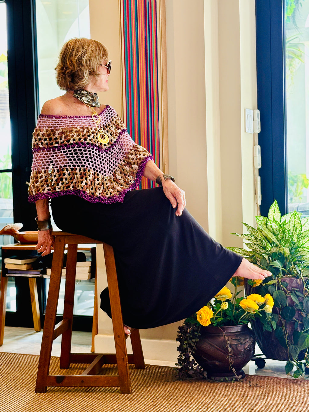 Artistic designer poncho worn in modern lifestyle setting