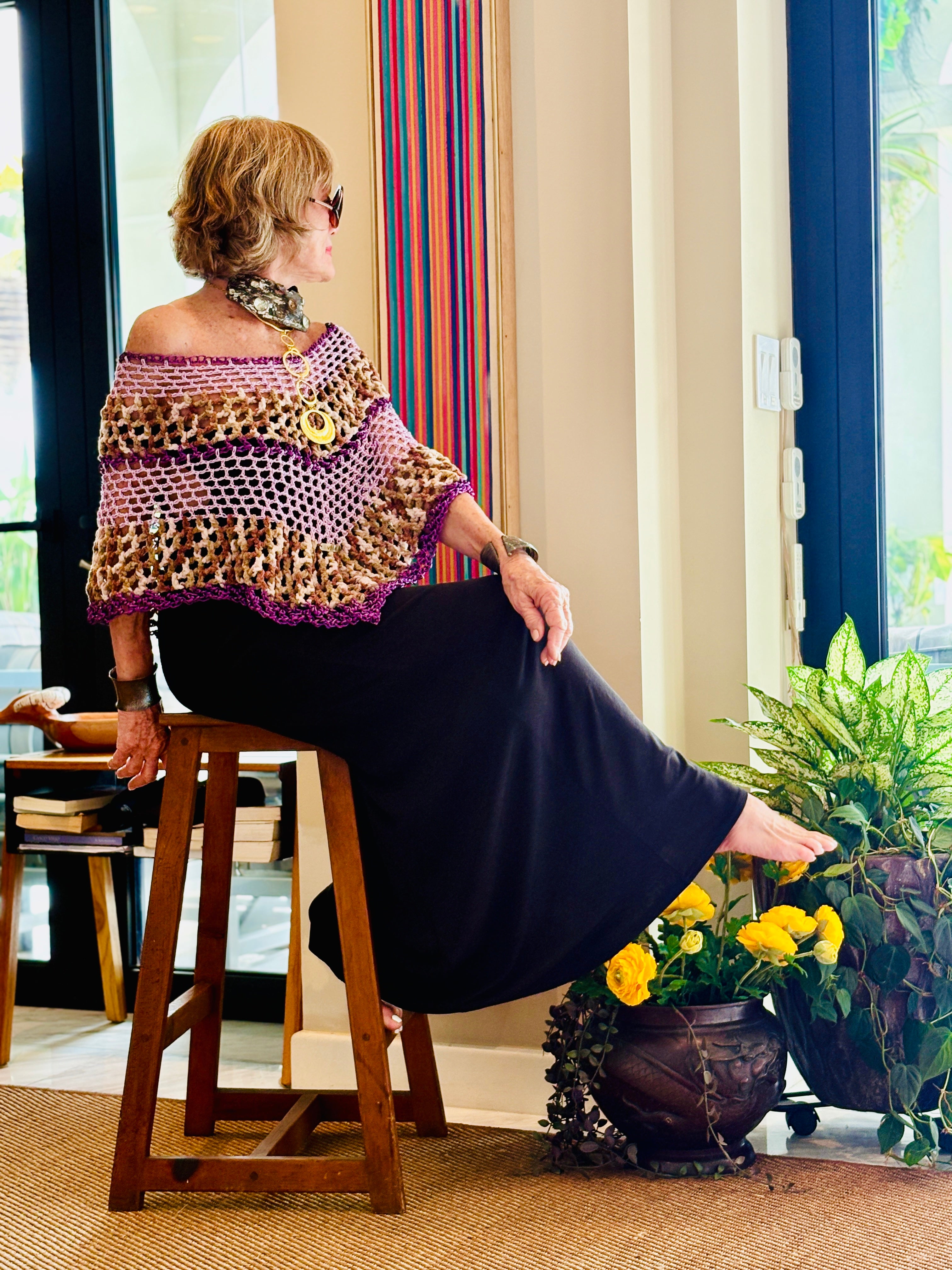 Artistic designer poncho worn in modern lifestyle setting