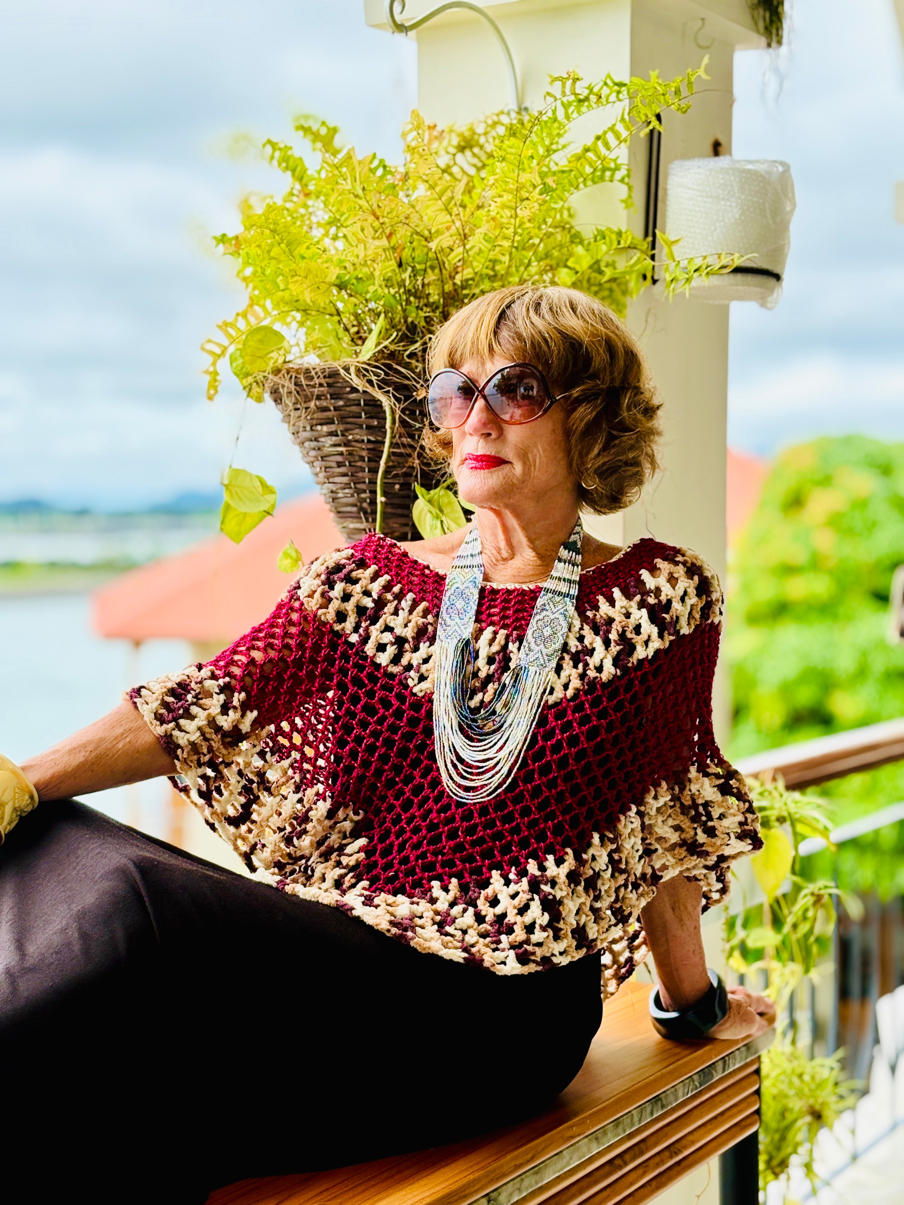 Crochet tiger pattern bordeaux poncho styled for elegant fashion look
