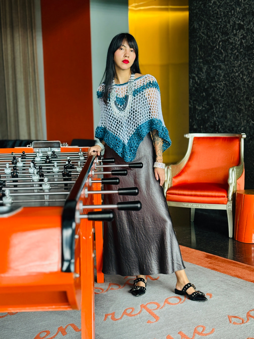 Model wearing blue velvet series poncho standing indoors