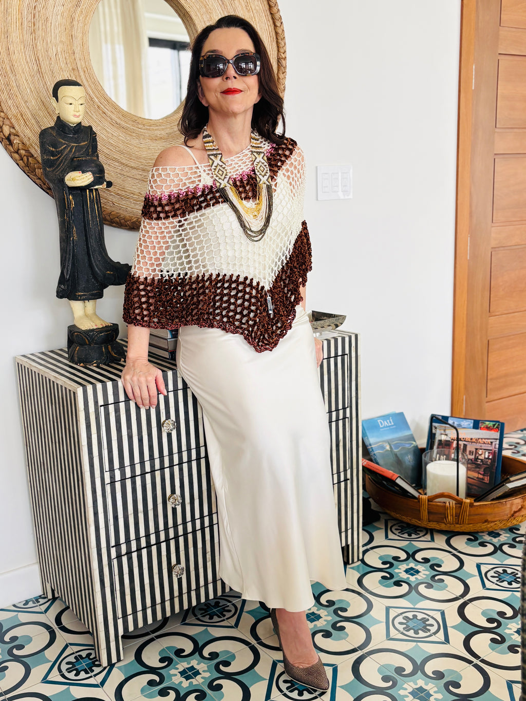 Brown and white velvet series poncho worn by woman in elegant front pose with statement jewelry