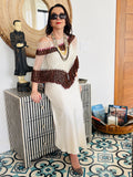 Brown and white velvet series poncho worn by woman in elegant front pose with statement jewelry
