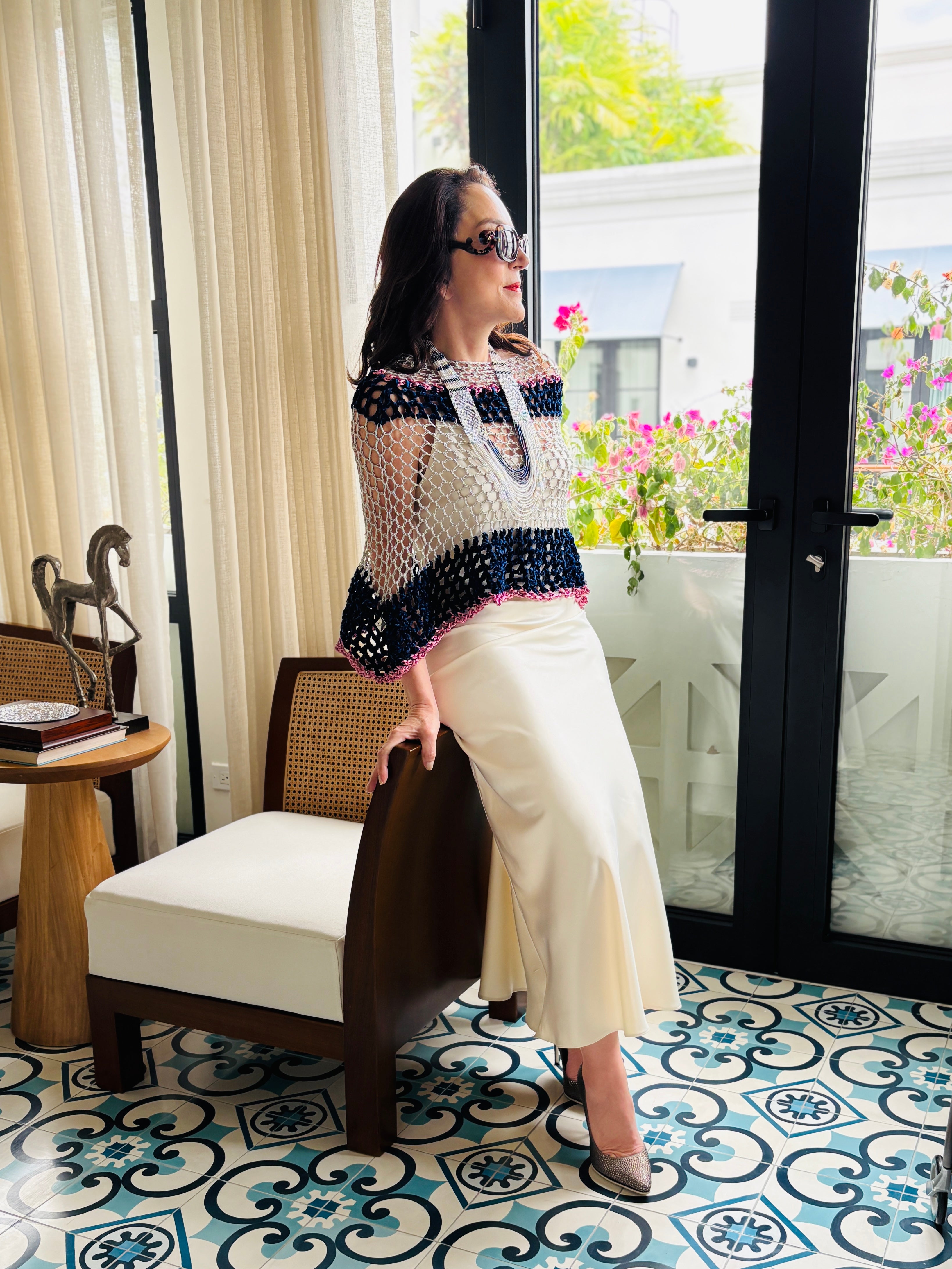 Full length styling of navy grey velvet poncho in modern interior setting with elegant silhouette